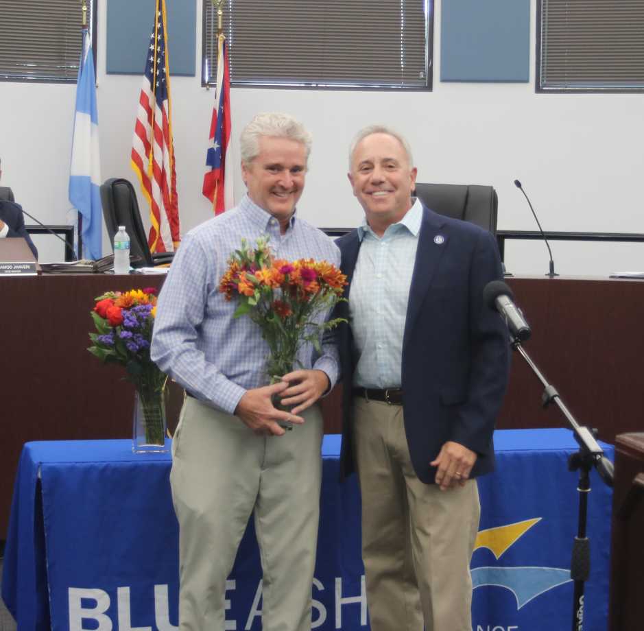 Mr. McClain with flowers and Mayor Sirkin